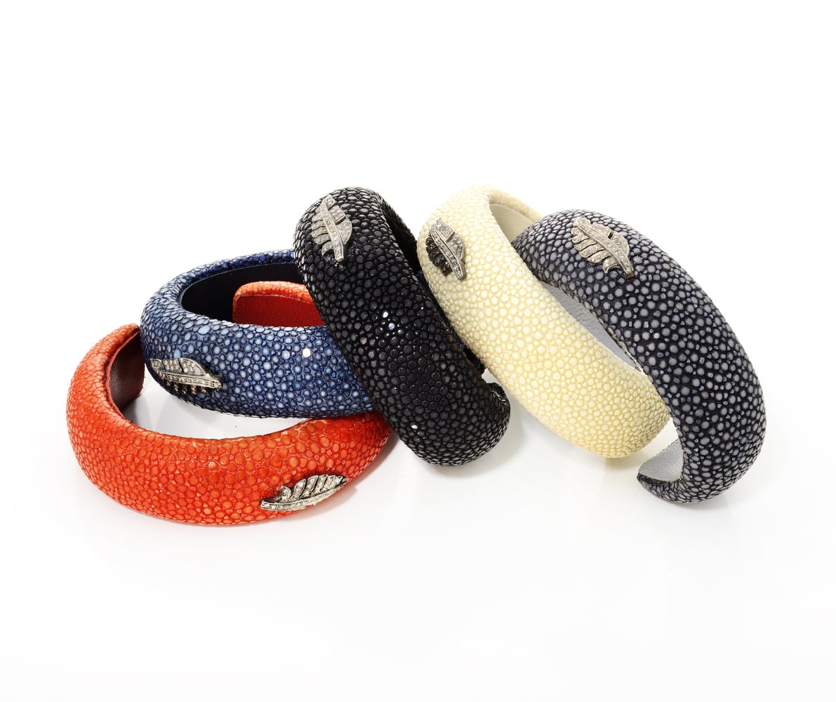 Stacked Multi colored Sting ray skin bangles with silver feather and diamond design on each all on white background Product Photography