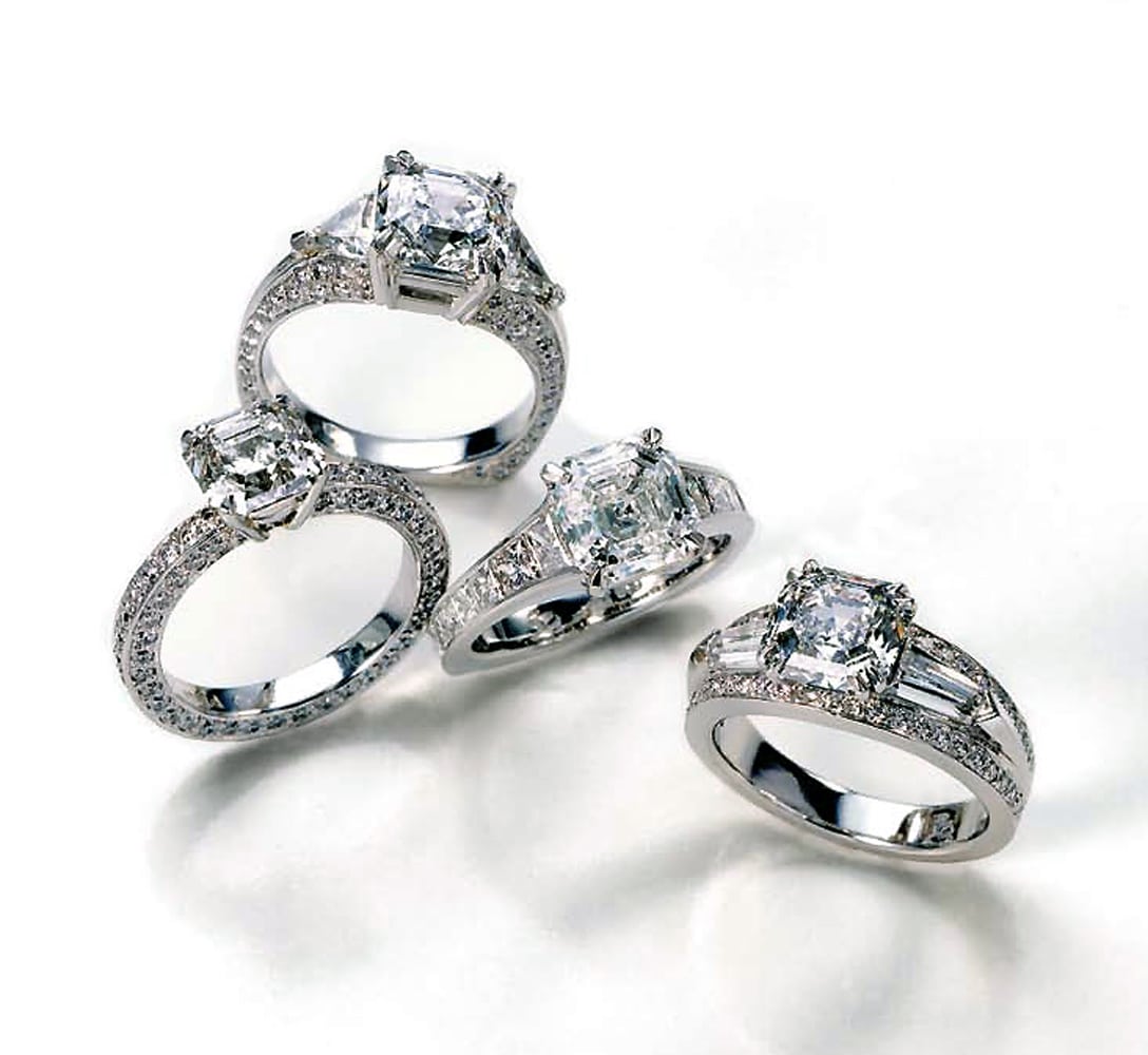 Four diamond ring arrangement with platinum settings and all with emerald cut diamonds viewed from above on white background