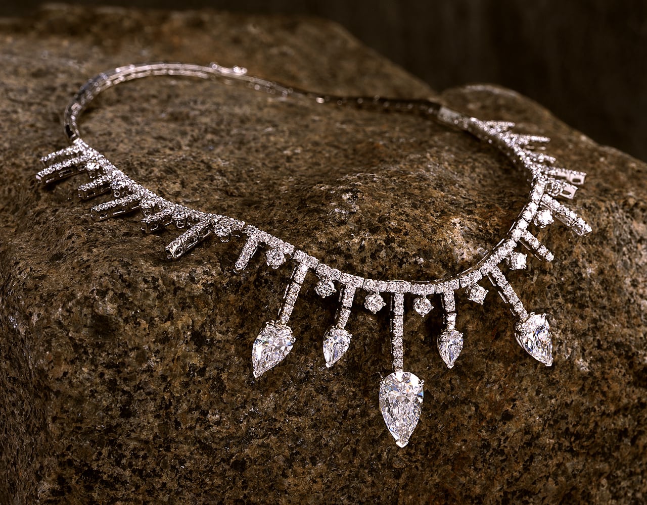 fancy diamond necklace with diamonds surrounding the strand and drops of diamond strands ending with large pear shaped diamonds
