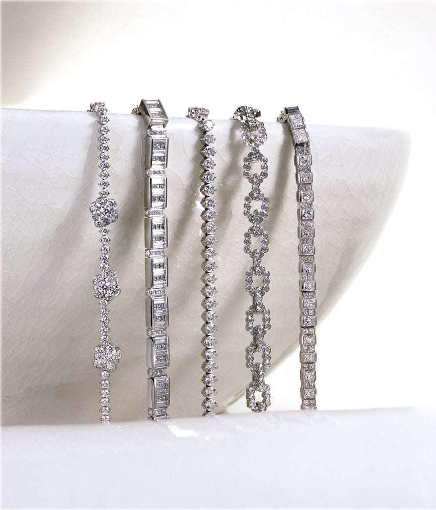 five diamond tennis bracelets spilling over edge of a white bowl
