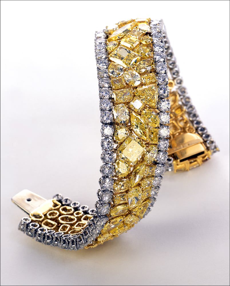 Large diamond bracelet with a Pave of large different shaped yellow diamonds in the middle and white round diamonds bordering it, twisted to stand up. Yellow Brick Road