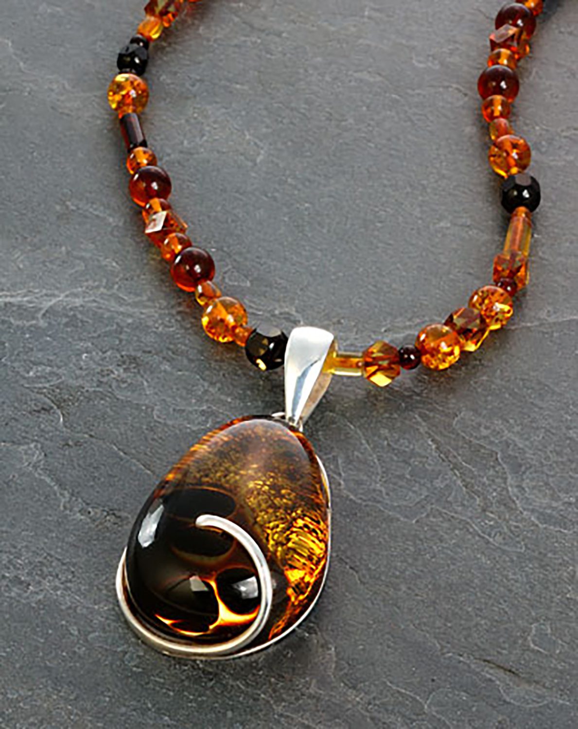 Amber pendant on gray slate background