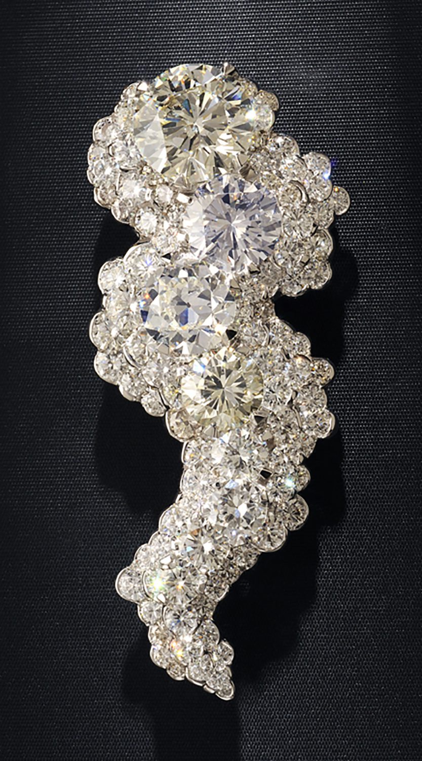 Museum quality Pave diamond pin in a tornado shape featuring several very large oval diamonds all on a black background Product Photography