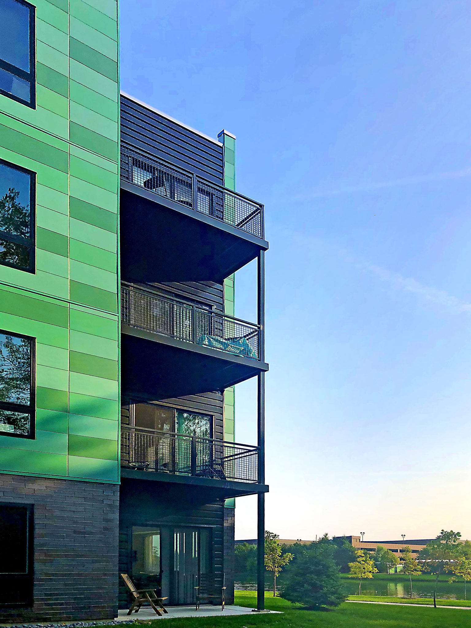 balconies on green apartment building at sun set