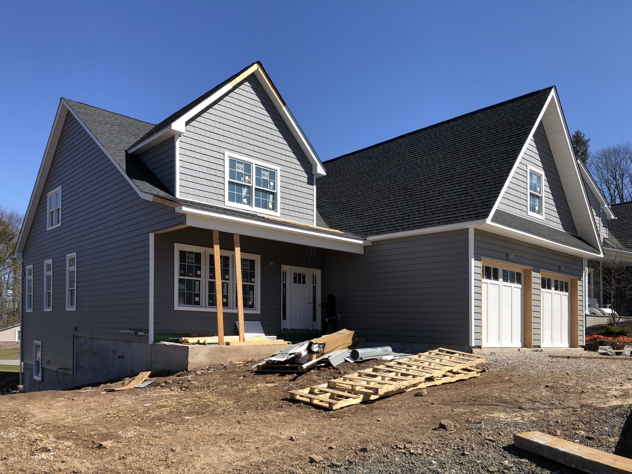 House under construction with temporary supports holding porch