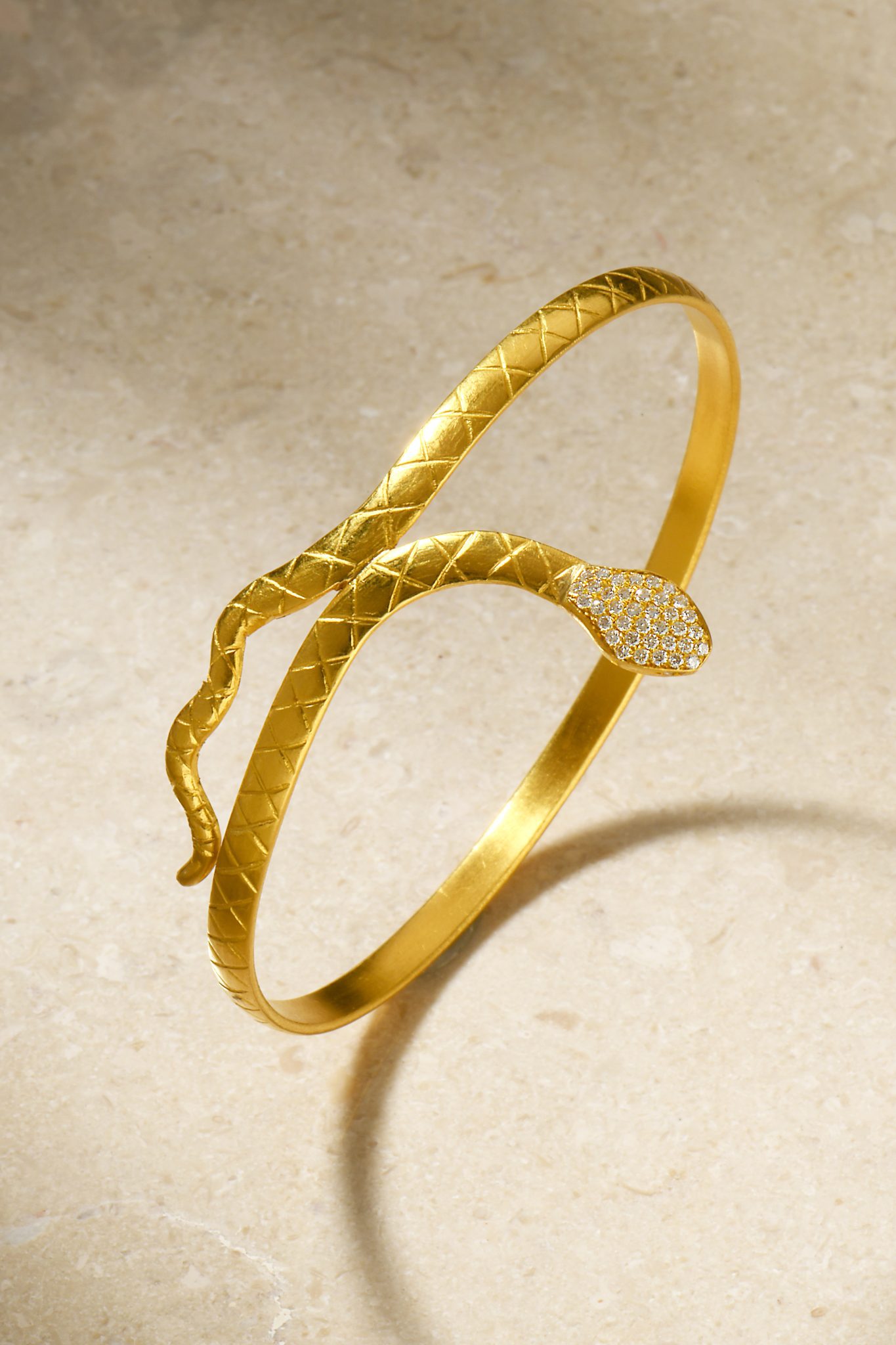 Snake bracelet standing up on brown stone background